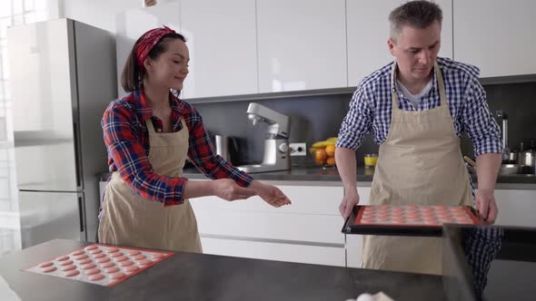 Couple Take Macaroons to the Oven