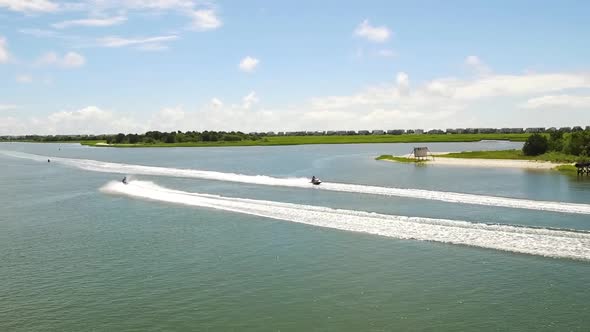 Drone tracking jet skis in the intra coastal waterway near Ocean Isle Beach NC during middle of the