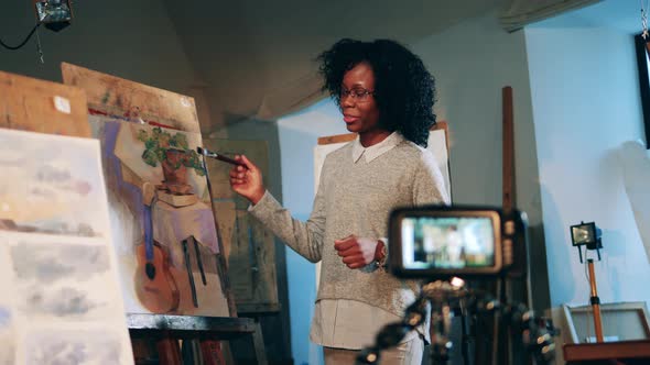 Art Lesson of an African Lady Is Being Filmed on a Camera