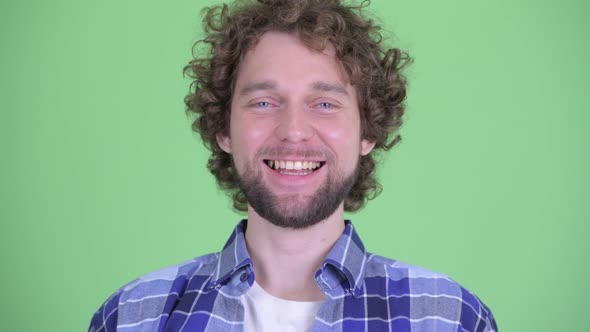 Face of Happy Young Bearded Hipster Man Smiling