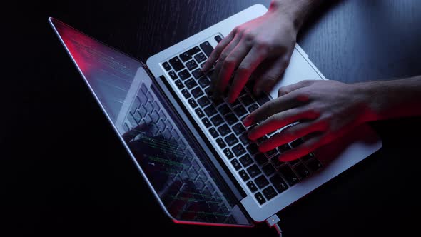 Male hands coding on laptop screen