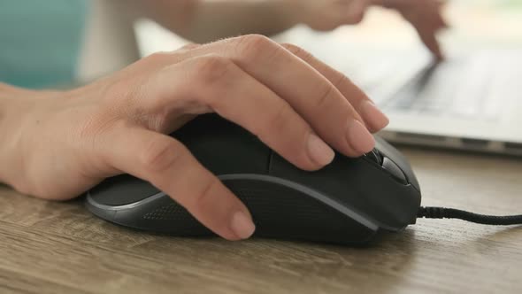 Hands Typing on Laptop with Mouse