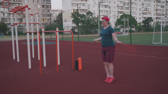 Woman Doing Jumping Rope Exercise at the Street Gym