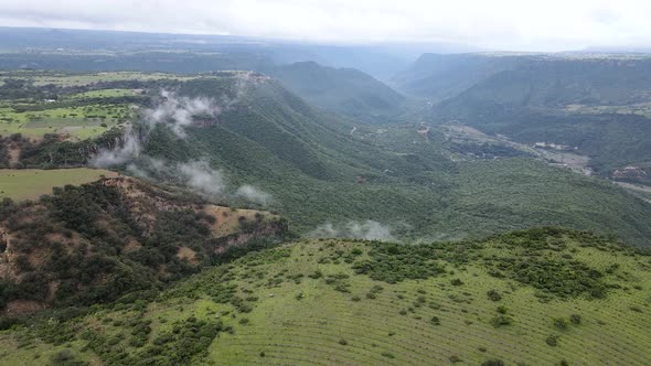 Frontal view of pena del aire canyon in a cloud day with a drone