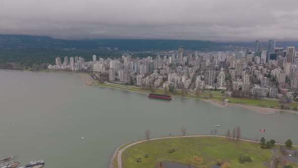 VANCOUVER, BRITISH COLUMBIA, CANADA  Barge stuck on Sunset Beach bank, aerial shot rotating around t