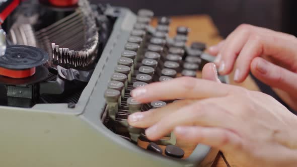 Woman's Hands on an Old Typewriter