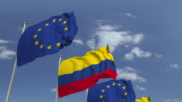 Flags of Colombia and the European Union Against Blue Sky