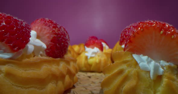 Macro Shot of Donuts with Cream and Strawberry Slices on a Dark Rosy Background Macro Lens Passing