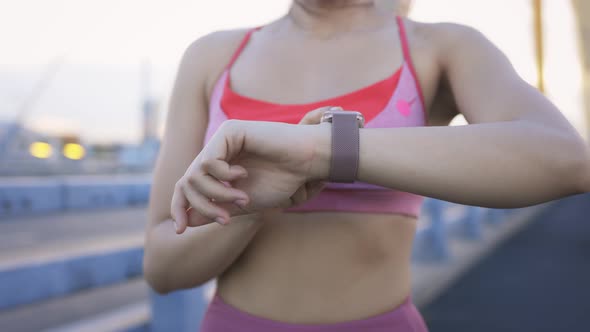 Woman Checking Watch While Running