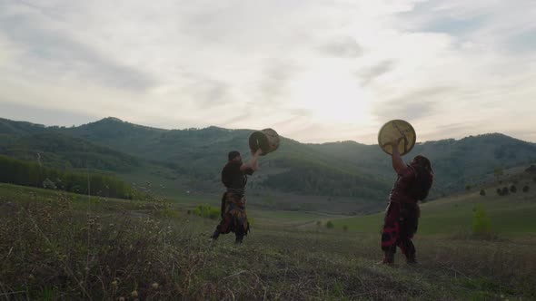 Performers in Traditional Shamanic Clothes Conduct Ritual