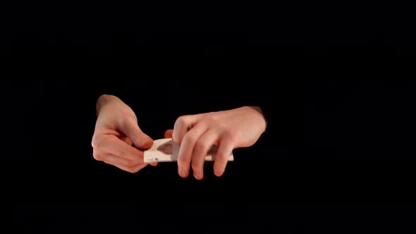 Magician Making Performance with Aces on Black Background