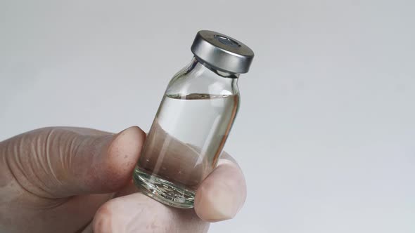 Vaccine Glass Bottle In Medical Doctor Hand