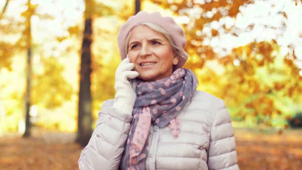 Senior Woman Calling on Smartphone at Autumn Park 7