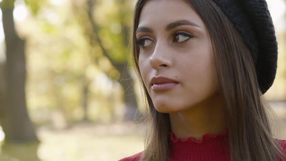 Portrait of Lady in Beret Pensively Looking at the Sky Near Camera in Park