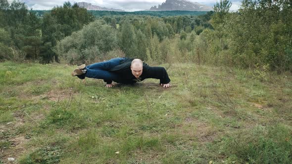 Caucasian Man is Engaged Traditional Chinese Gymnastics Qigong and Tai Chi