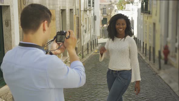 Happy Young Couple Taking Photos at Old City Street