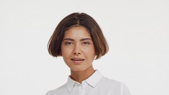 Young Beautiful Brunette East Asian Female in Shirt Flirting at Camera Smiling Showing Tongue Waving