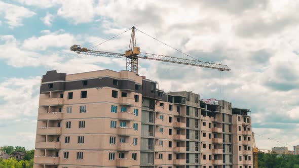 Time Lapse of Working Construction Crane Building. Beautiful Clouds Move Quickly Against Background