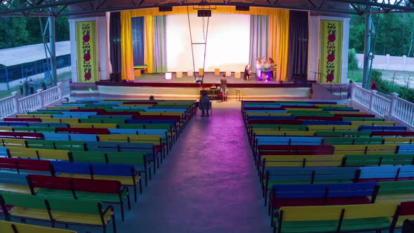 Timelapse of Stage in Children's Camp, Spectators in Crowd Take Places in Hall