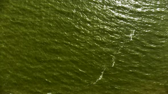 AERIAL: Still shot of Baltic Sea with waves rippling through the surface of water