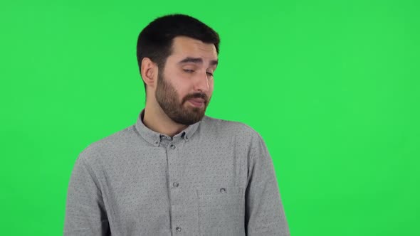 Portrait of Brunette Guy Is Waiting and Yawning with Boredom. Green Screen