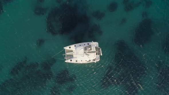 Aerial view of a catamaran anchored in Aegean sea, Greece.