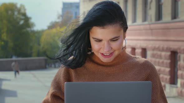 Girl Freelancer Student Typing on Laptop Outdoors Looking for Useful Information for Work or Study