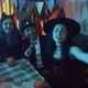 A Group of Friends are Sitting at a Table in Creepy Costumes Taking Pictures with a Camera and - VideoHive Item for Sale