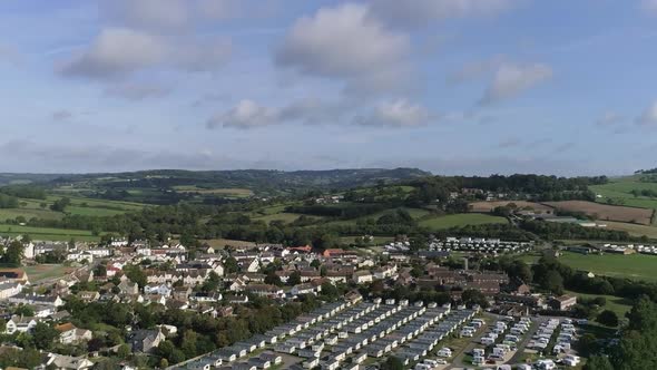 The village of Charmouth aerial. Tracking forward and inland over the river Char, the old village an