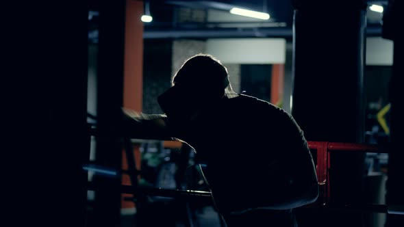 An Athlete in VR Glasses Workouts in Modern Gym.