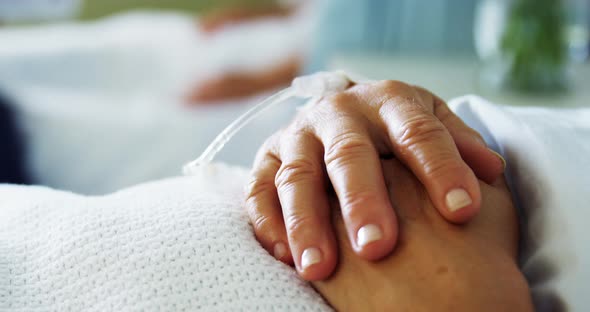 Male doctor comforting patient in the ward