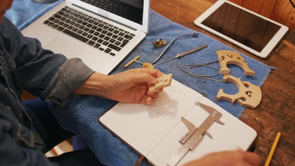 Female luthier at work in her workshop