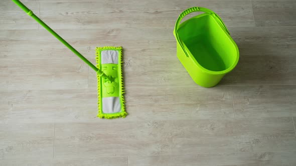 Cleaning the parquet floor with a wet mop