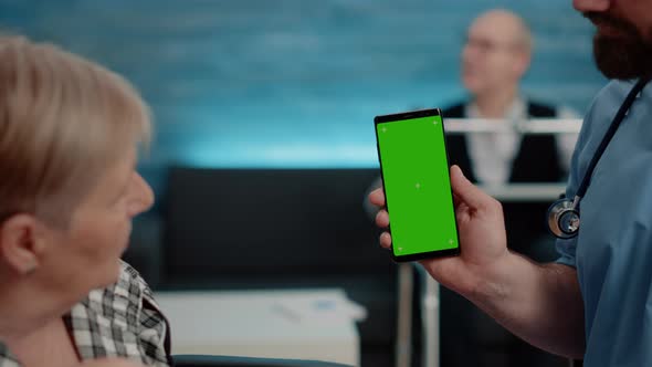 Close Up of Nurse Vertically Showing Phone with Green Screen