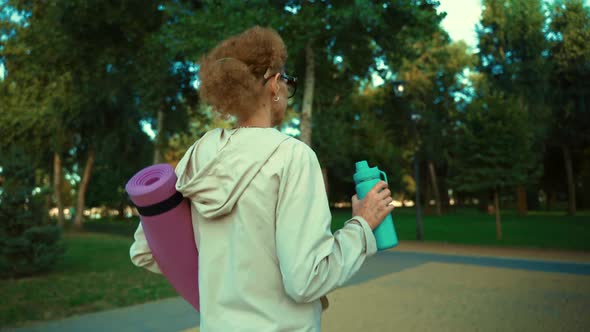 Happy Senior Woman Going on Sport Training Carry Yoga Mat