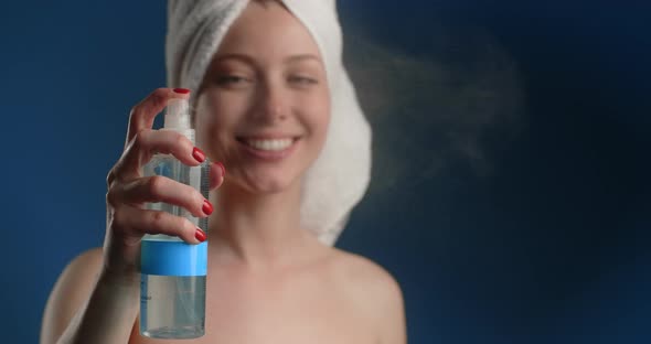 Woman in the Towel Sprays Tonic Water After Bath