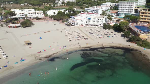 Aerial footage of the Spanish island of Ibiza showing the beautiful beach front and hotels