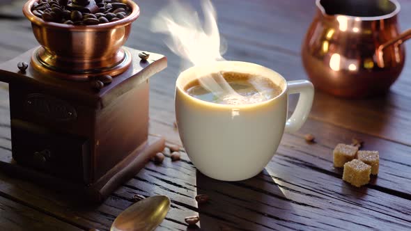 Coffee cup with freshly brewed coffee on an old vintage table.