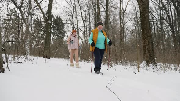 Active Elderly Woman with Her Daughter Practice Nordic Walking