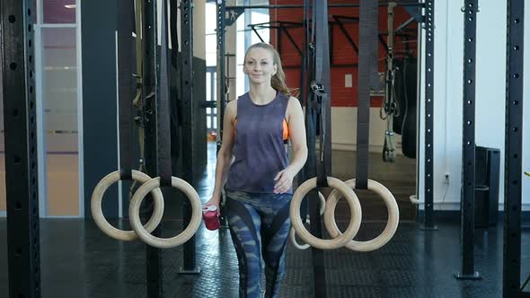 Young Sports Woman Passing at Fitness-Gym. Fit Girl Entering a Fitness Club alt