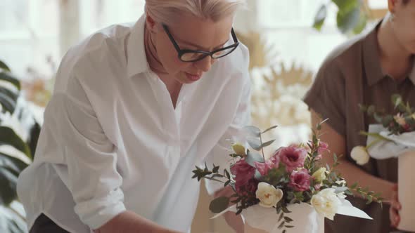 Blonde Woman Making Flower Arrangement during Masterclass