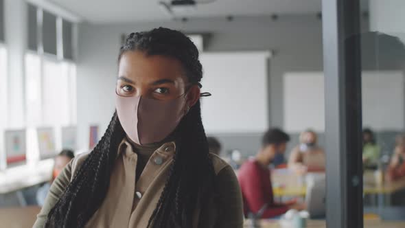 Portrait of Afro-American Woman in Protective Mask at Work in Office