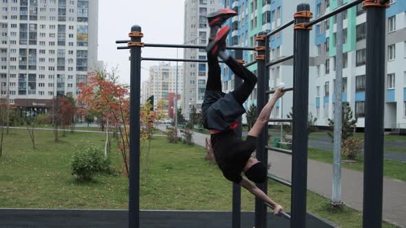 Muscular man training outdoors on sports field