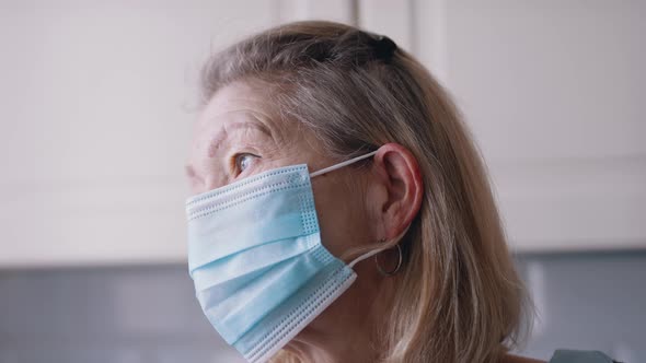 Portrait of Old Woman with Face Mask Alone at Home