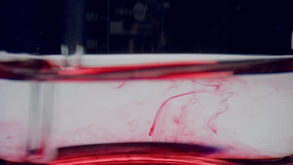 Test Tube with Water and Red Reagent. Closeup Laboratory Glassware with Blood alt