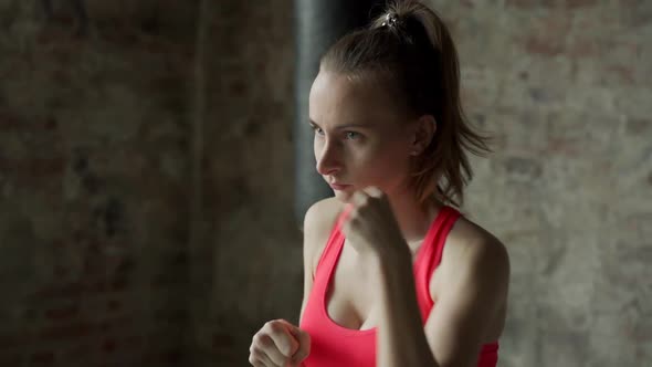 Slow Motion Athletic Woman Punching Air with Her Fists