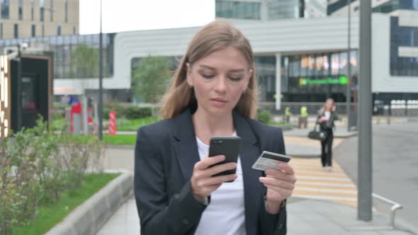 Businesswoman Making Online Payment on Smartphone While Walking Outside