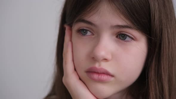 Portrait of a Sad Beautiful Girl with Blue Eyes  Teen Crying Holding His Head