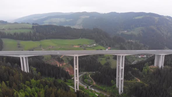 Aerial View of the Highway Viaduct on Concrete Pillars with Traffic in Mountains