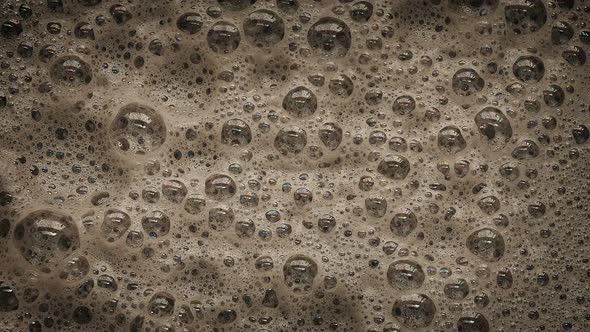 Dark Foam With Bubbles Popping